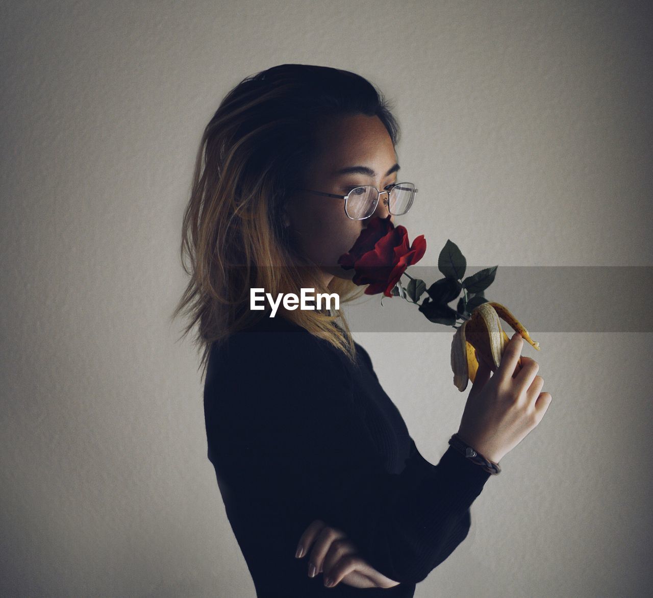 Young woman smelling flower