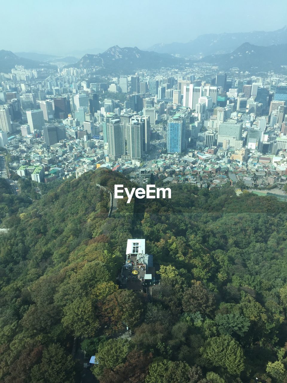 AERIAL VIEW OF CITY AGAINST MOUNTAIN