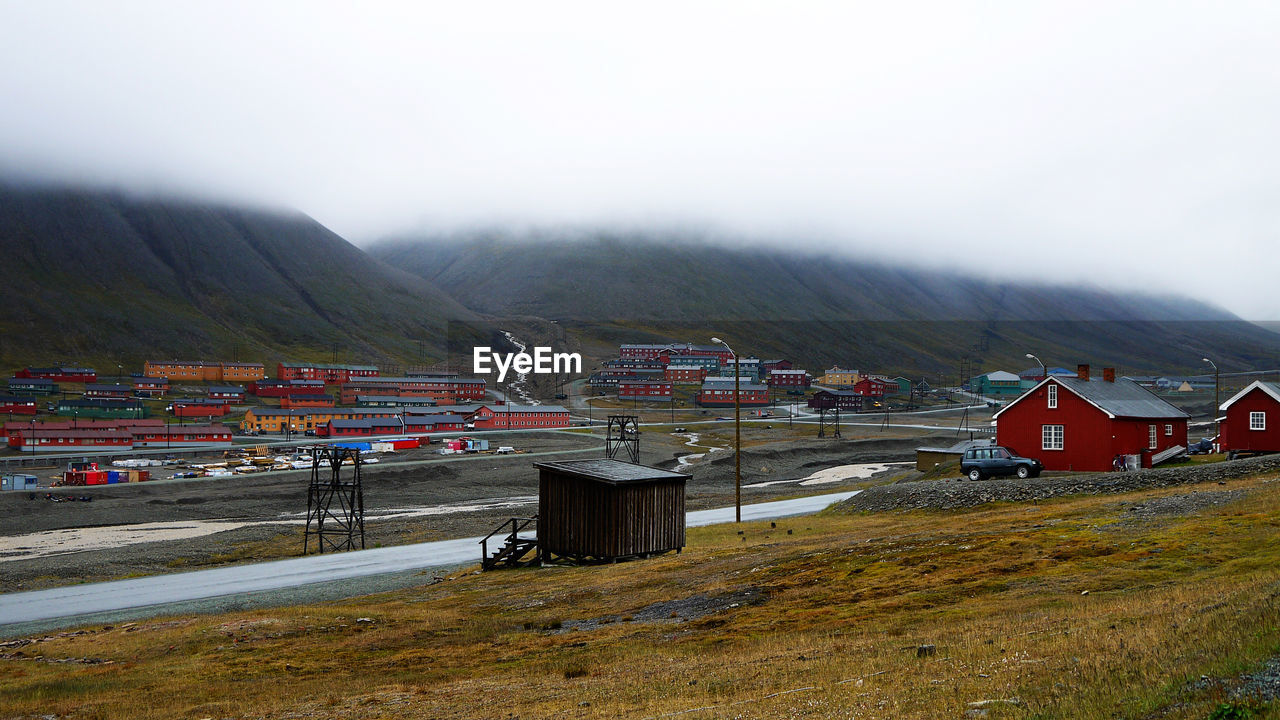 Houses and buildings on mountain against sky