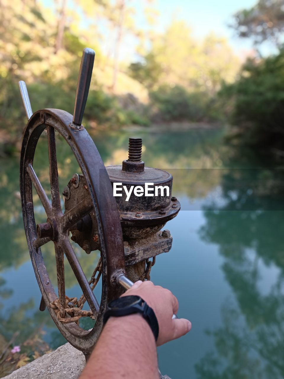 water, nature, one person, cannon, lake, focus on foreground, day, outdoors, hand, weapon, history, tree, metal, the past, transportation, plant, wheel