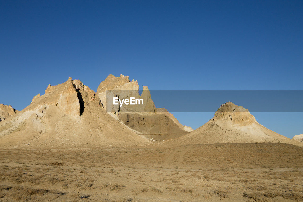 scenic view of desert against clear sky