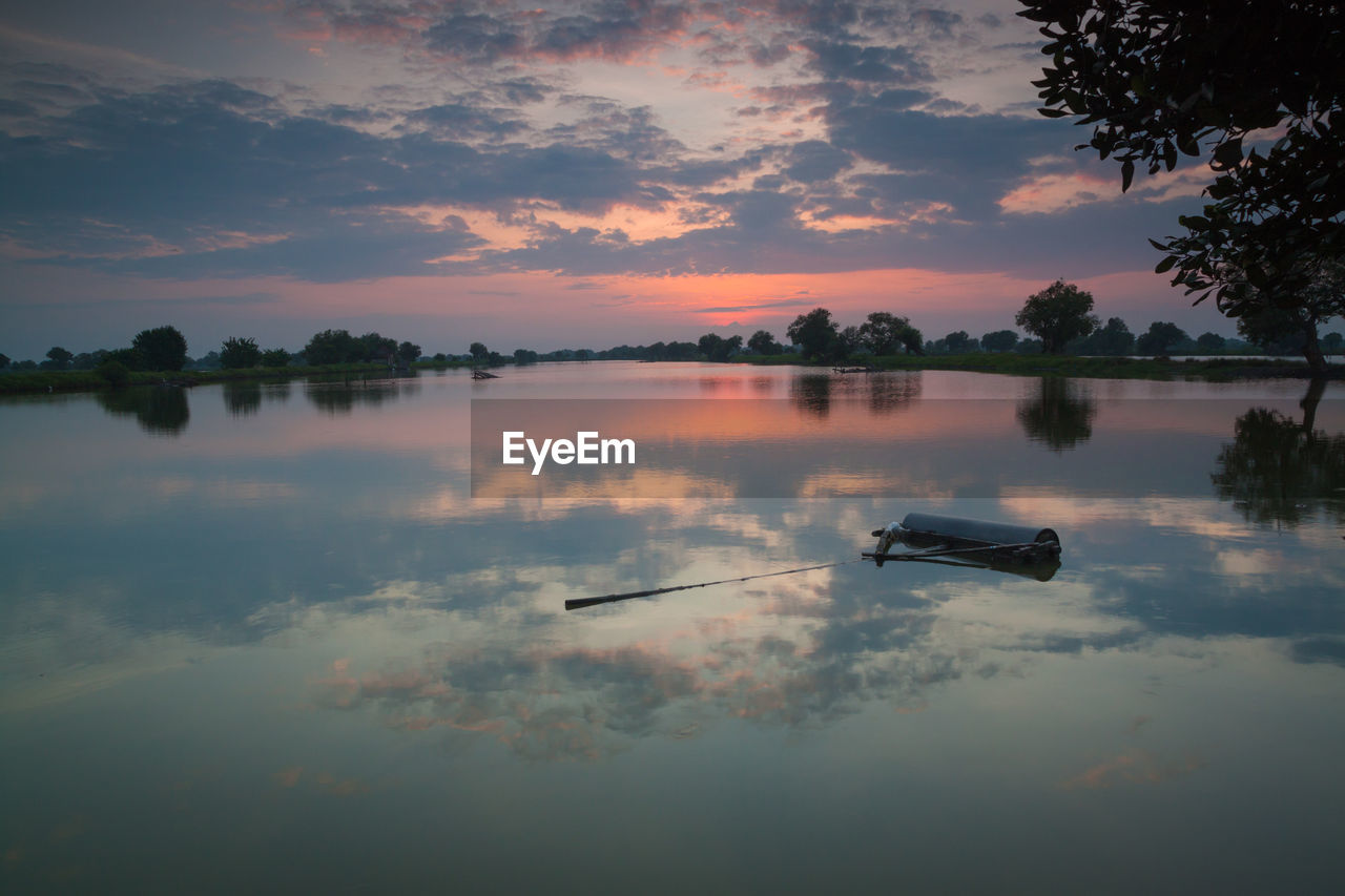 SCENIC VIEW OF LAKE AT SUNSET