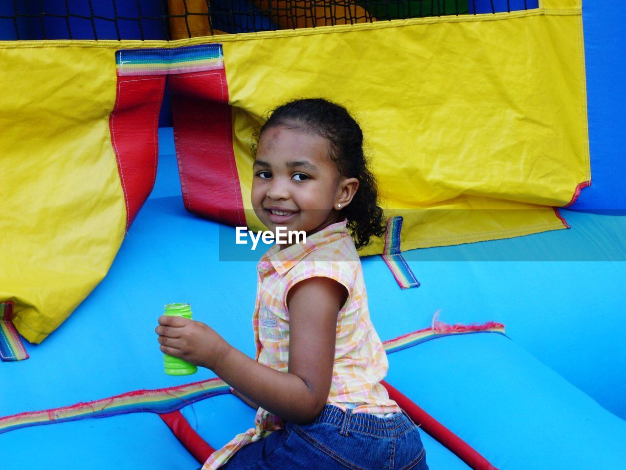 Portrait of smiling cute girl in bouncy castle