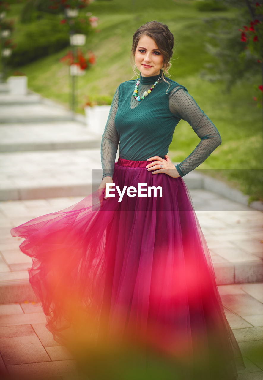 Portrait of woman smiling while standing on steps