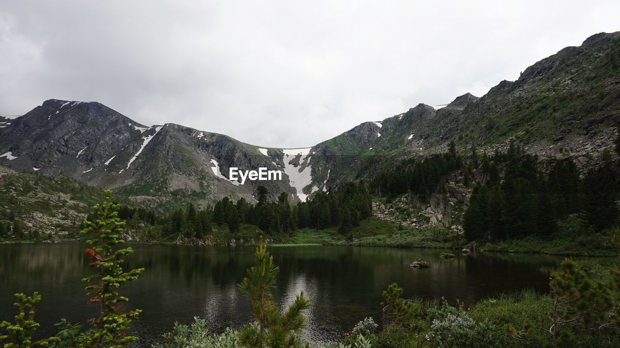 Scenic view of lake and mountains against sky