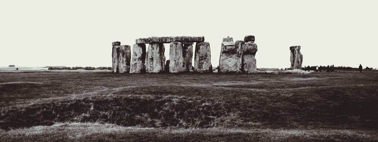 Panoramic view of stonehenge on field against sky