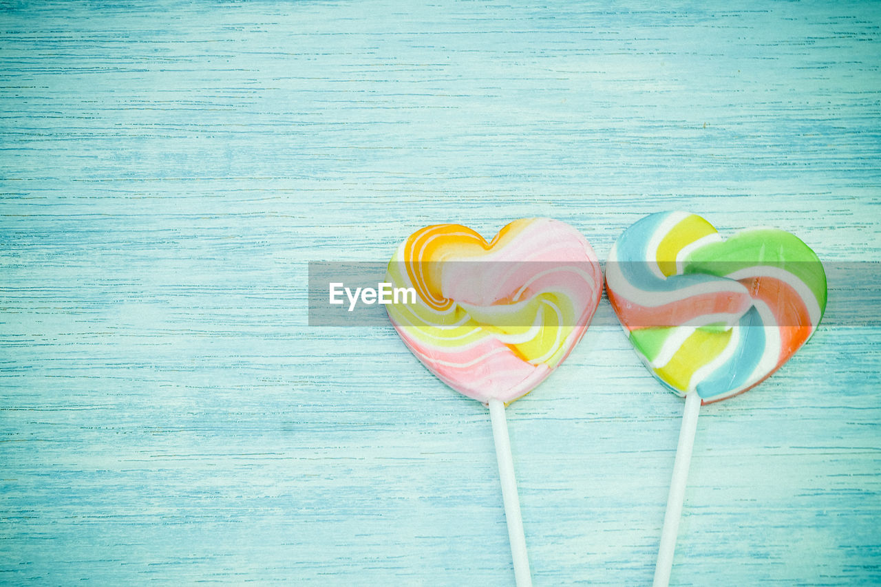 Close-up of colorful heart shape lollipops on table