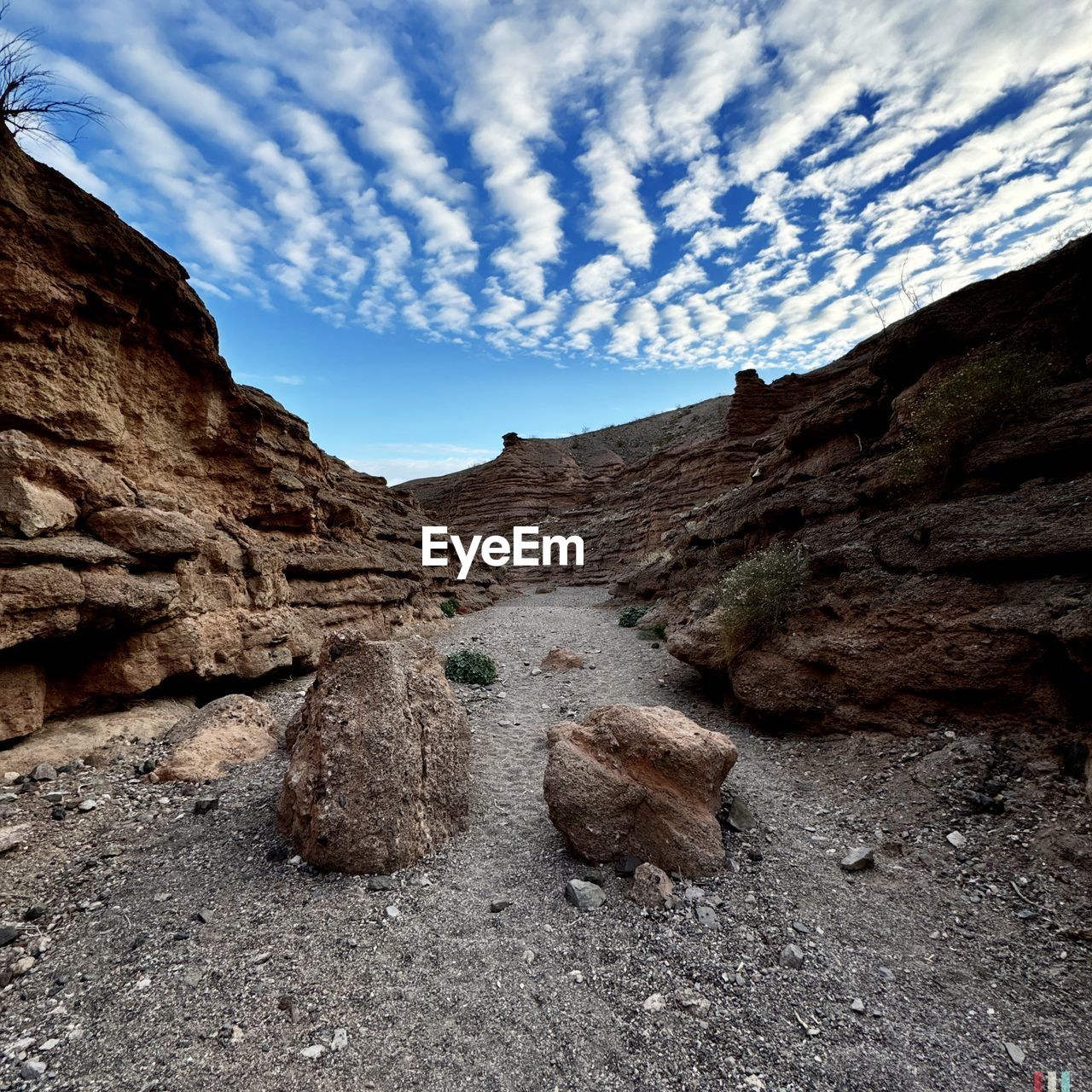 sky, cloud, rock, scenics - nature, nature, landscape, environment, beauty in nature, mountain, land, non-urban scene, rock formation, no people, travel destinations, tranquility, wilderness, travel, geology, valley, tranquil scene, outdoors, day, extreme terrain, mountain range, terrain, tourism, remote, physical geography