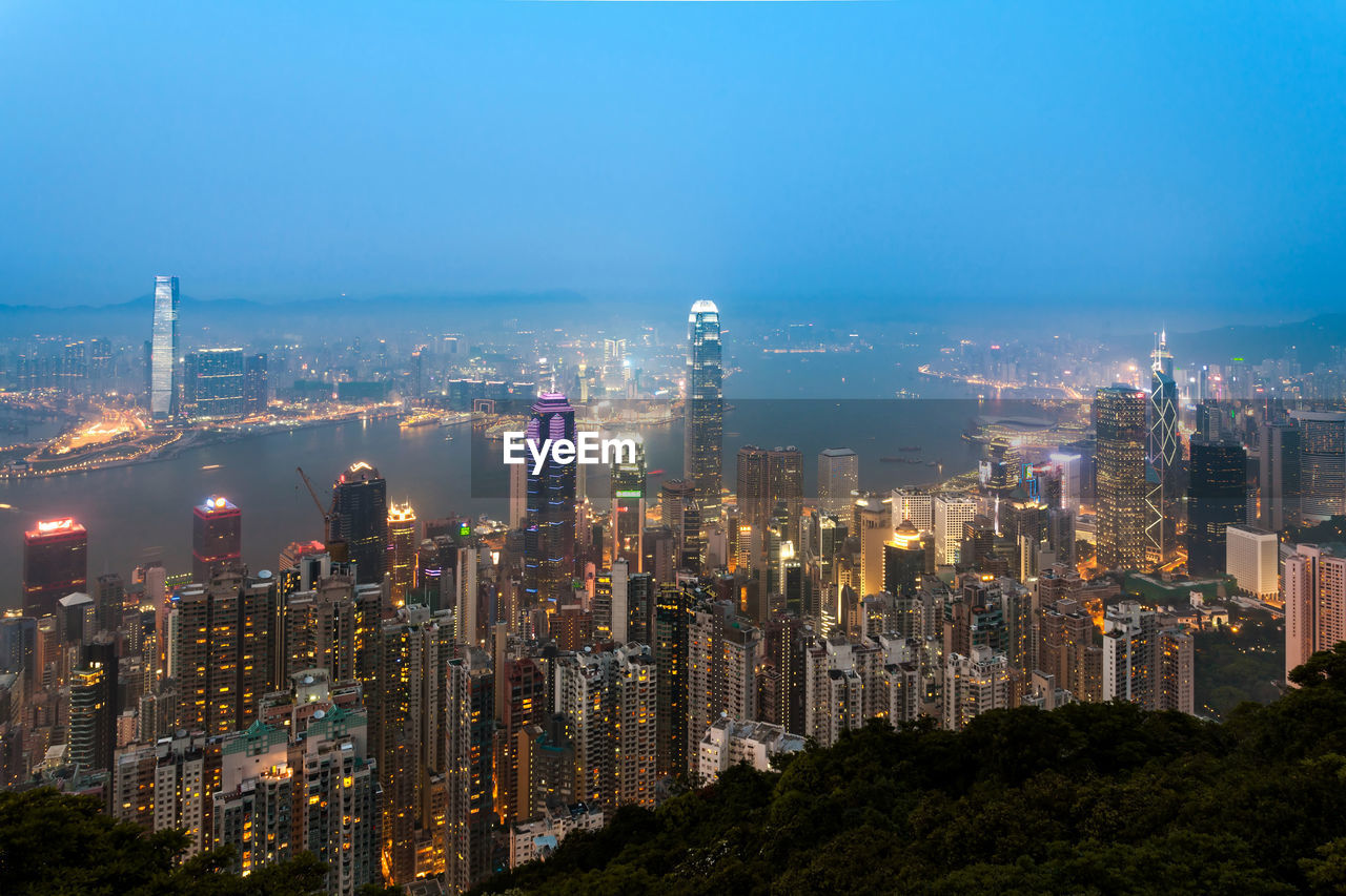 Illuminated cityscape against sky at night