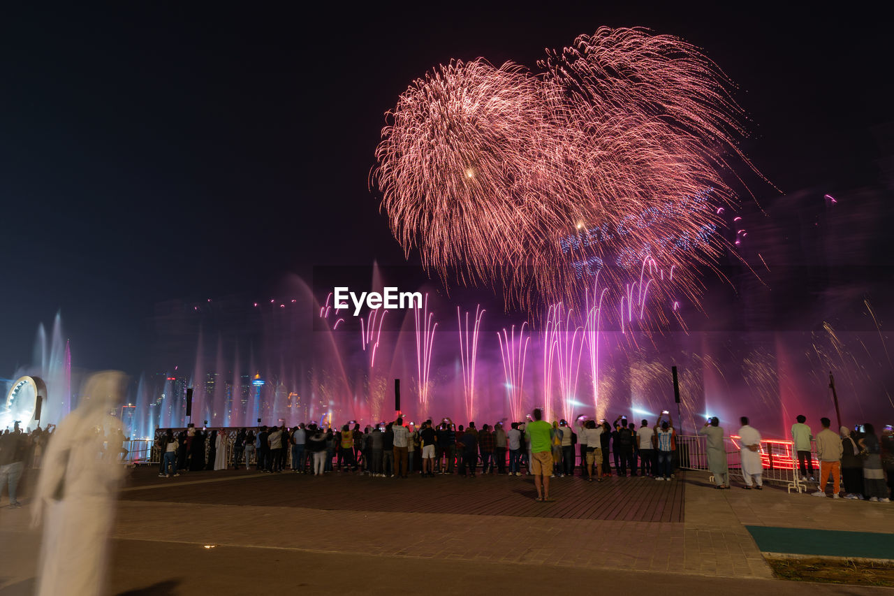 fireworks, event, celebration, firework display, night, motion, arts culture and entertainment, recreation, exploding, illuminated, large group of people, architecture, new year's eve, group of people, crowd, firework - man made object, long exposure, sky, nature, city, outdoors, blurred motion, travel destinations, multi colored, building exterior, built structure