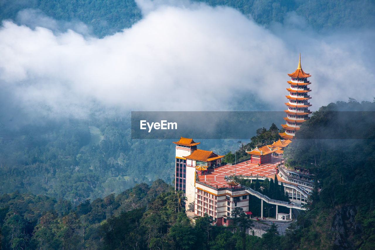 Panoramic view of buddhist temple in a forest against sky located in genting highland