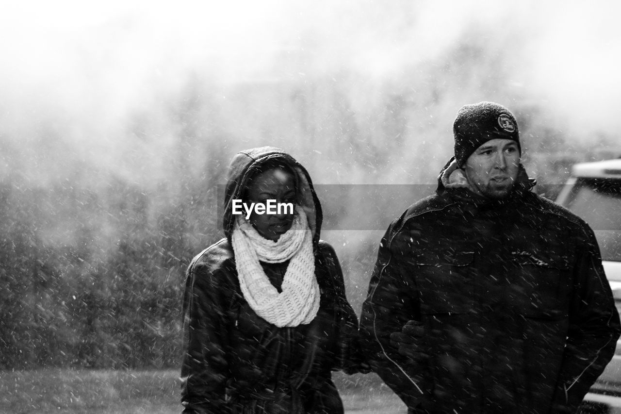 MAN AND WOMAN IN SNOW DURING WINTER