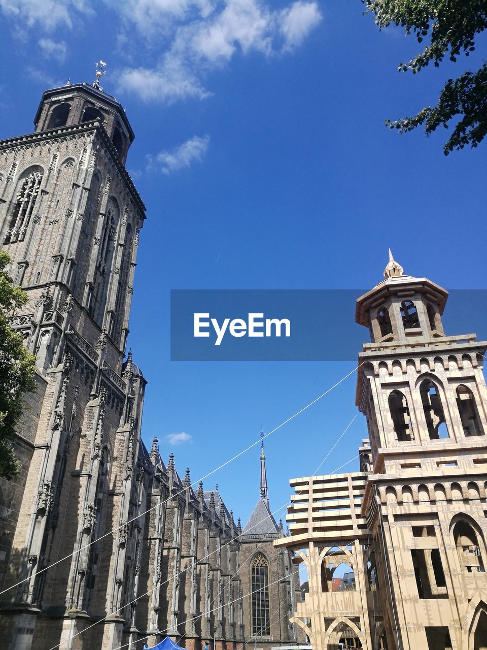 LOW ANGLE VIEW OF BUILDING AGAINST BLUE SKY