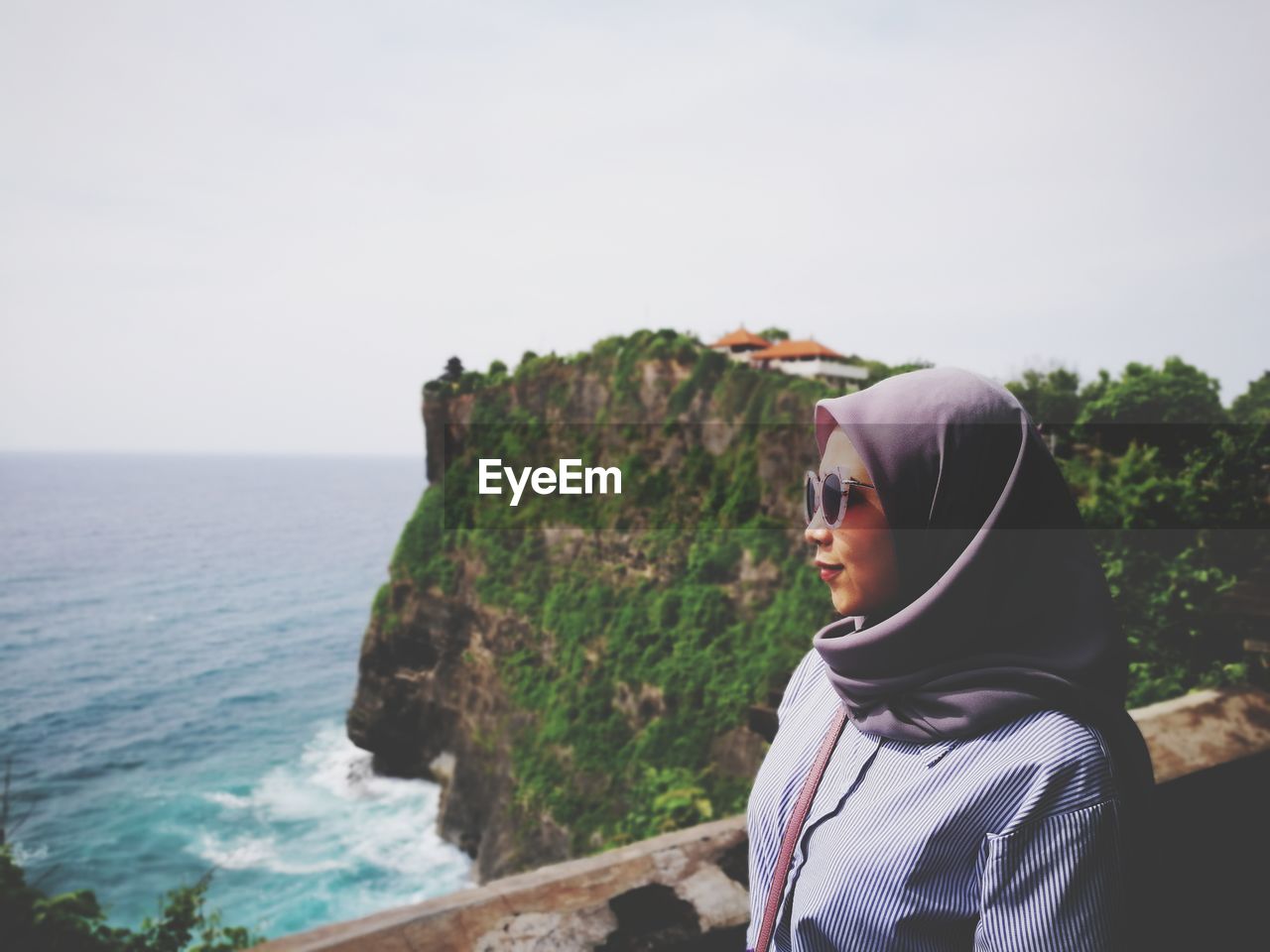 Woman looking at sea against clear sky