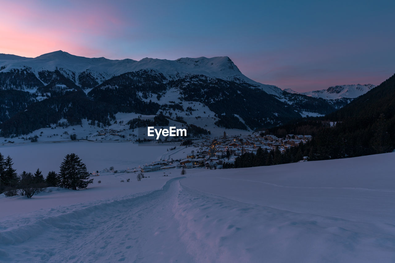 Scenic view of snow mountains against sky during sunset