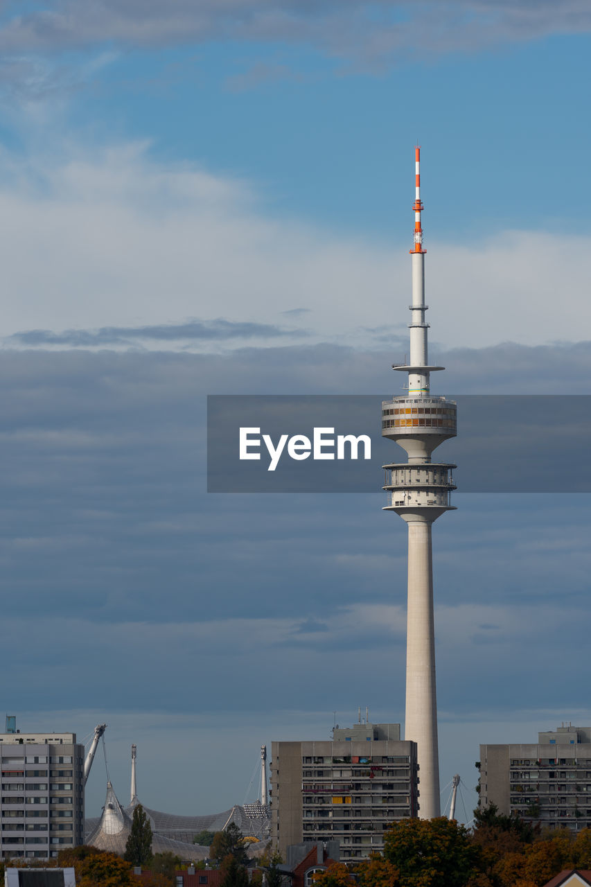 TOWER AMIDST BUILDINGS AGAINST SKY