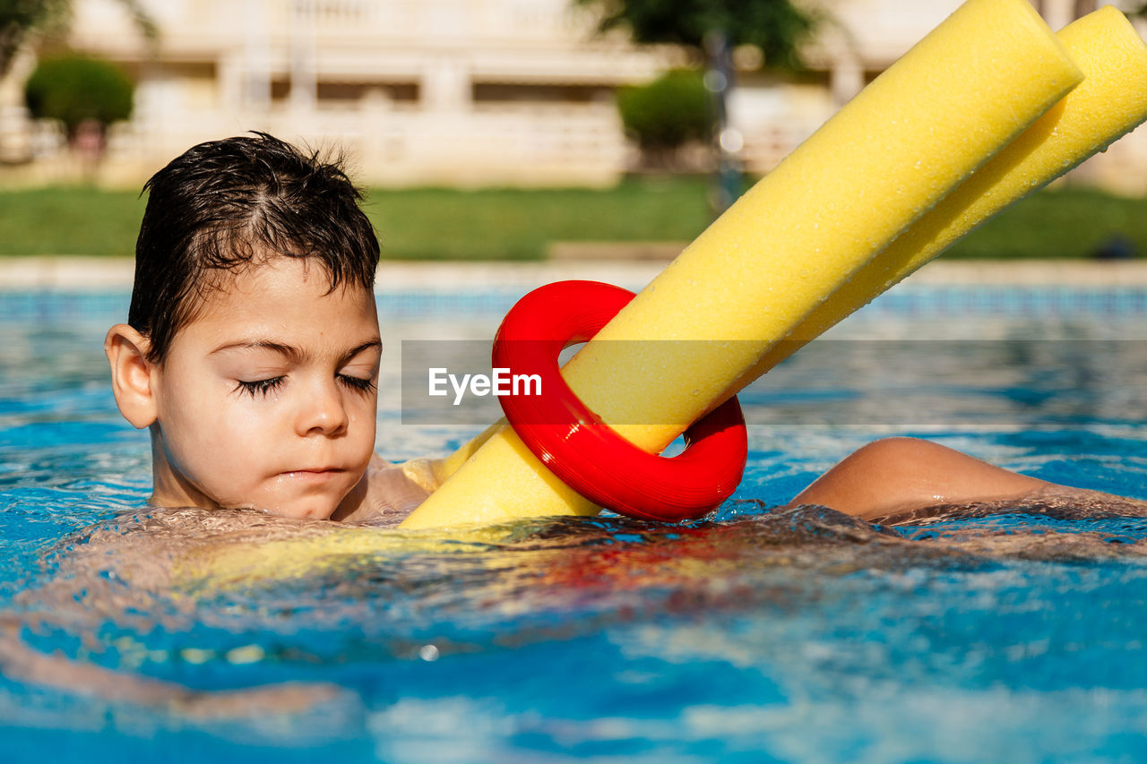 Boy swimming in pool