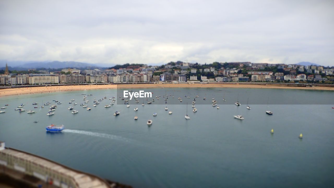 water, sea, reflection, architecture, sky, nature, cloud, built structure, building exterior, city, travel destinations, shore, transportation, day, coast, nautical vessel, no people, body of water, animal, animal themes, travel, wildlife, beach, outdoors, bird, morning, land, animal wildlife, vehicle, building, mode of transportation, harbor, ship, horizon, bay, group of animals, beauty in nature, tourism, scenics - nature, cityscape