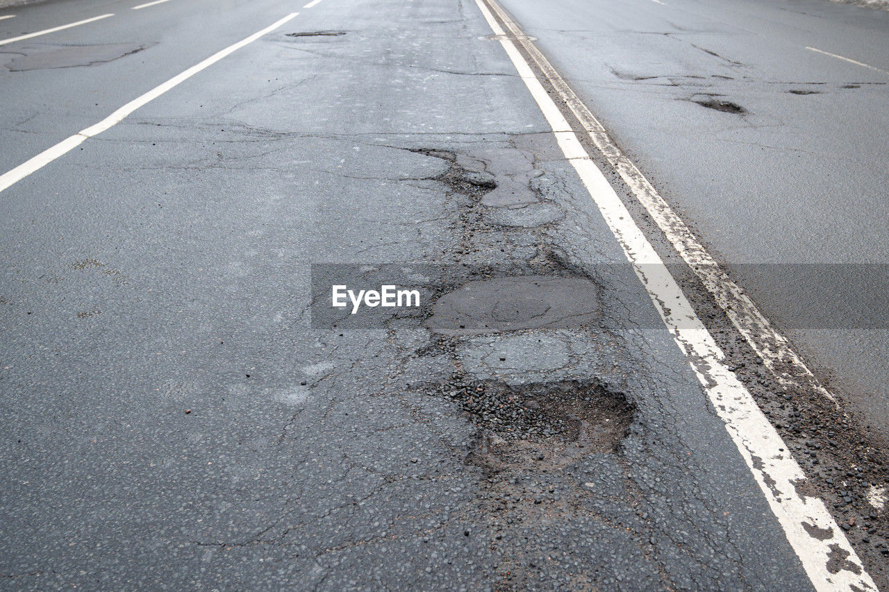 road surface, road, asphalt, lane, transportation, sign, symbol, road marking, marking, tarmac, city, sidewalk, street, infrastructure, no people, day, high angle view, the way forward, pedestrian crossing, line, zebra crossing, outdoors, nature, highway, communication, dividing line, empty road