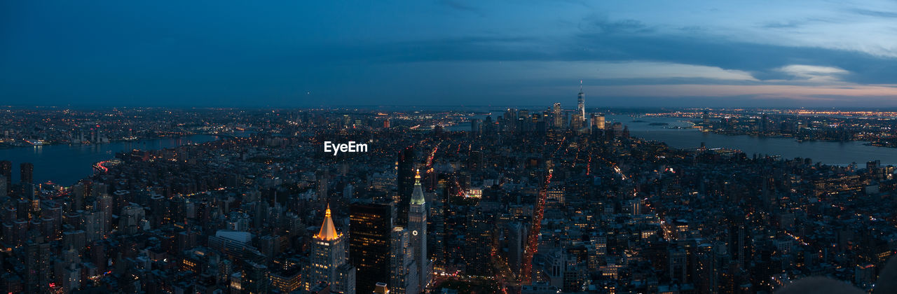 High angle view of city lit up at dusk