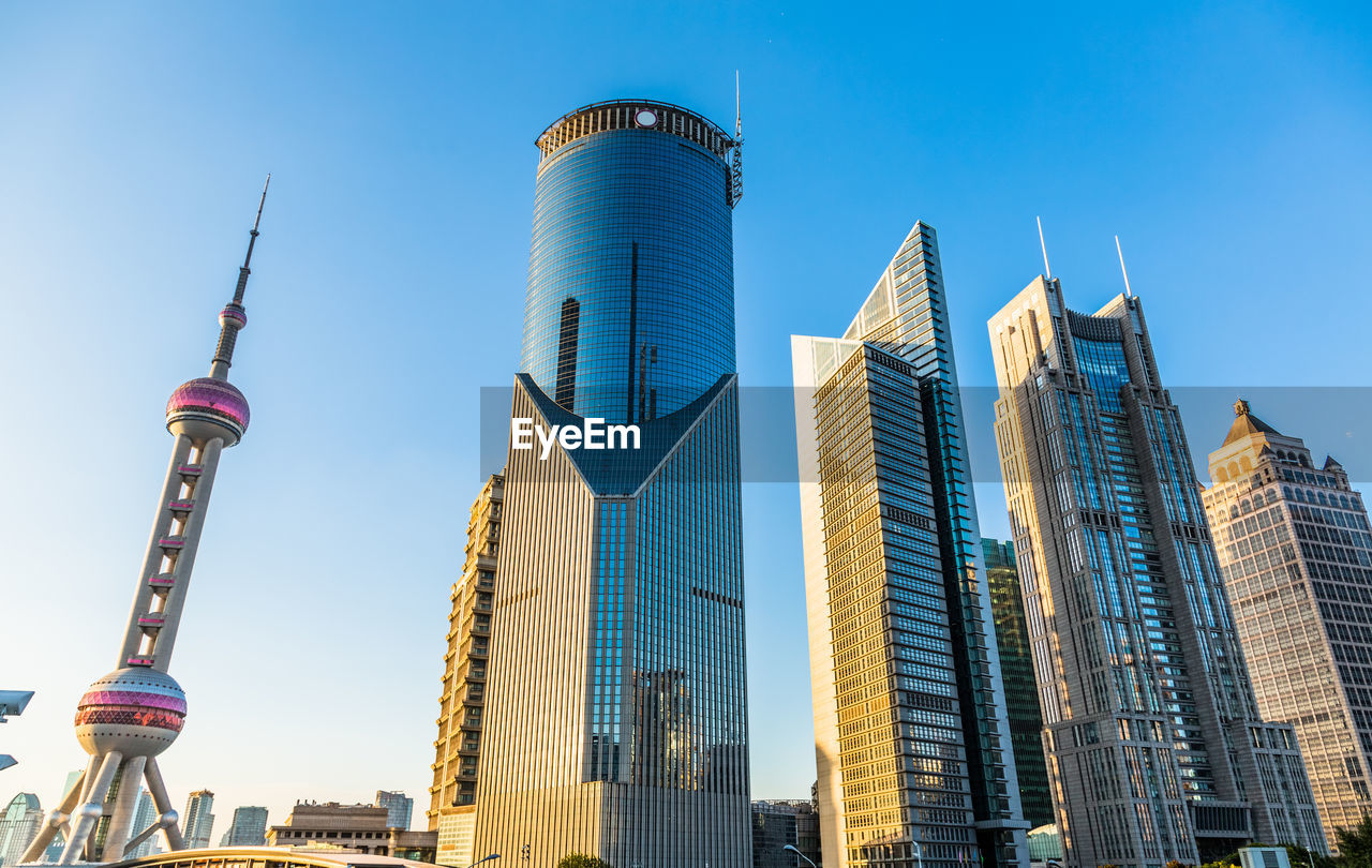 LOW ANGLE VIEW OF BUILDINGS AGAINST CLEAR BLUE SKY