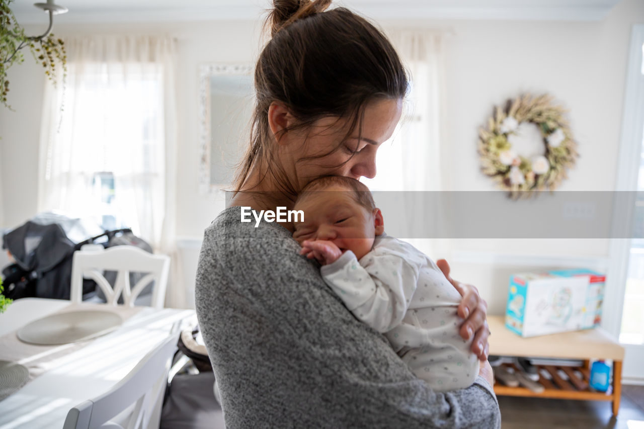 New mother in love holding her precious baby.