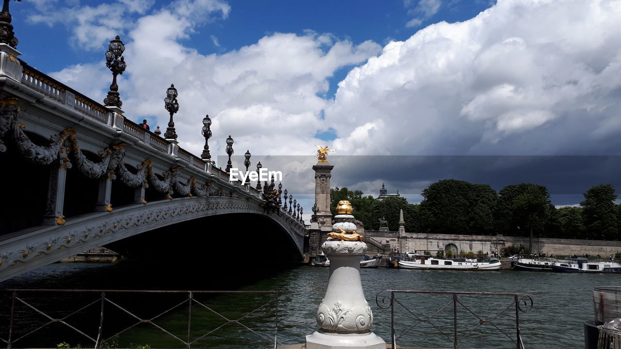 Bridge against cloudy sky