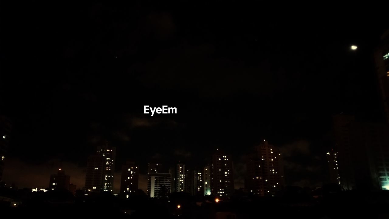 ILLUMINATED BUILDINGS AGAINST SKY AT NIGHT