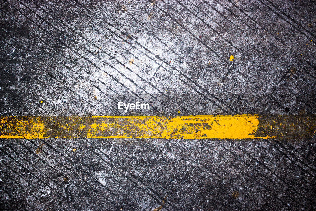 High angle view of yellow road marking on street