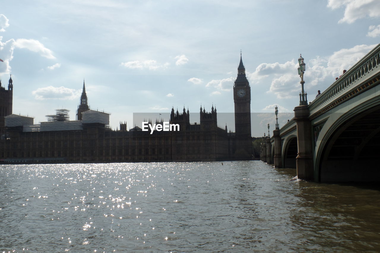 VIEW OF BUILDINGS BY RIVER AGAINST SKY