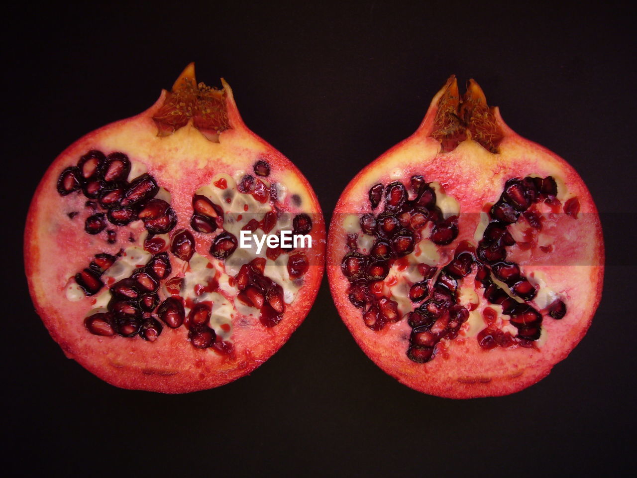 Cross section of pomegranate against black background