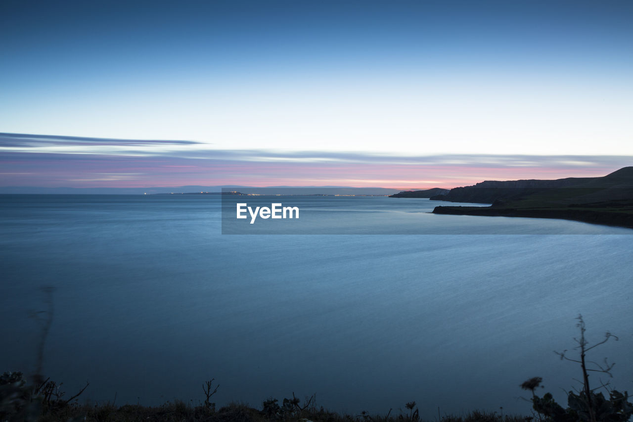 Scenic view of sea against sky at sunset