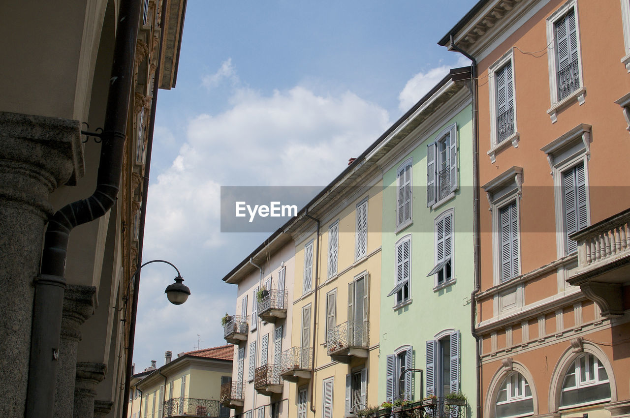 View of some beautiful and pastel colored building facades in the city center of como in italy