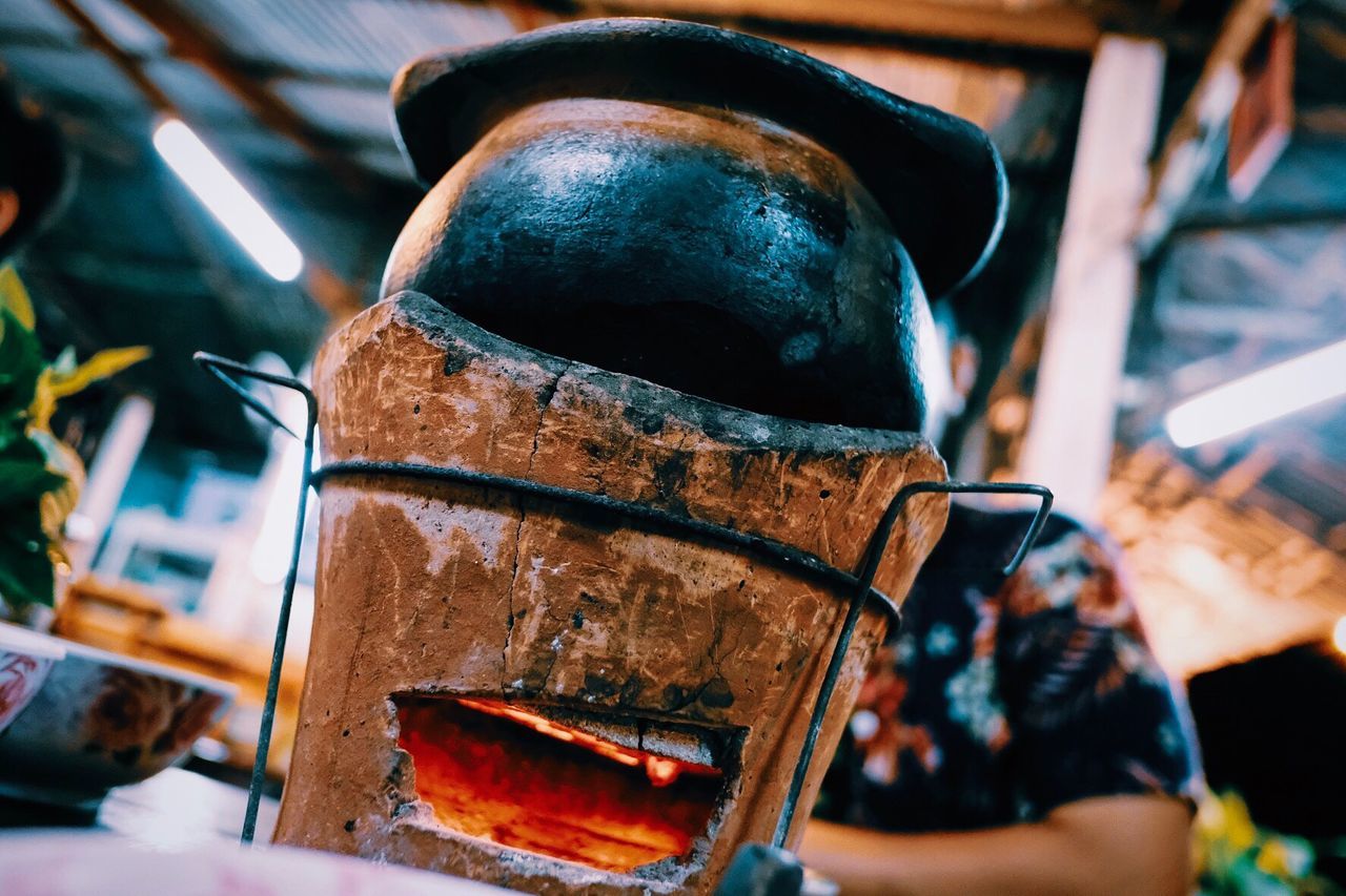 Low angle view of traditional stove on table