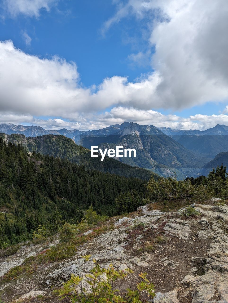 scenic view of mountains against cloudy sky