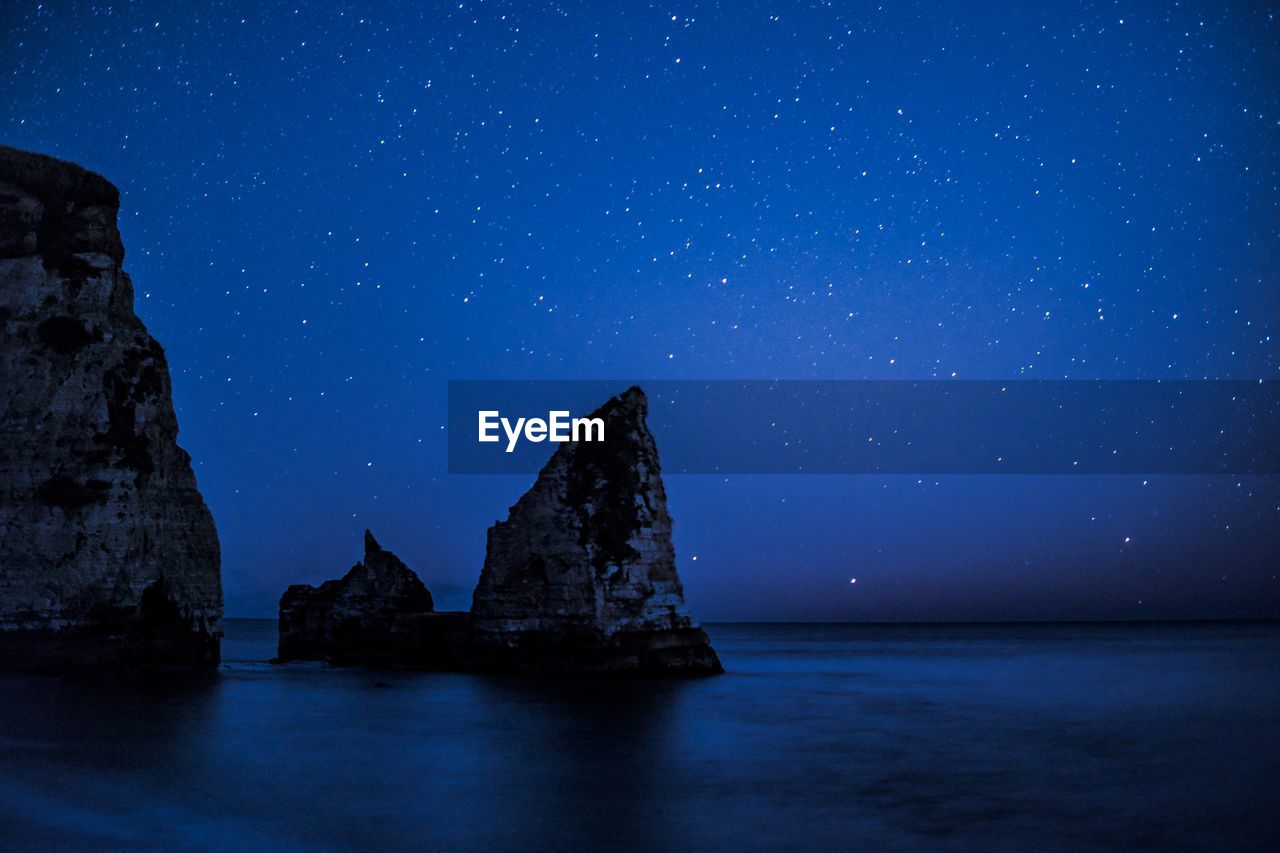 Scenic view of sea against sky at night