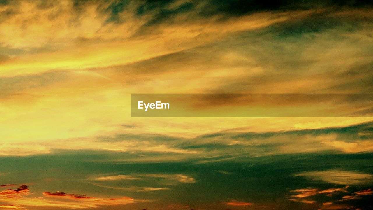 LOW ANGLE VIEW OF DRAMATIC SKY OVER SILHOUETTE LANDSCAPE