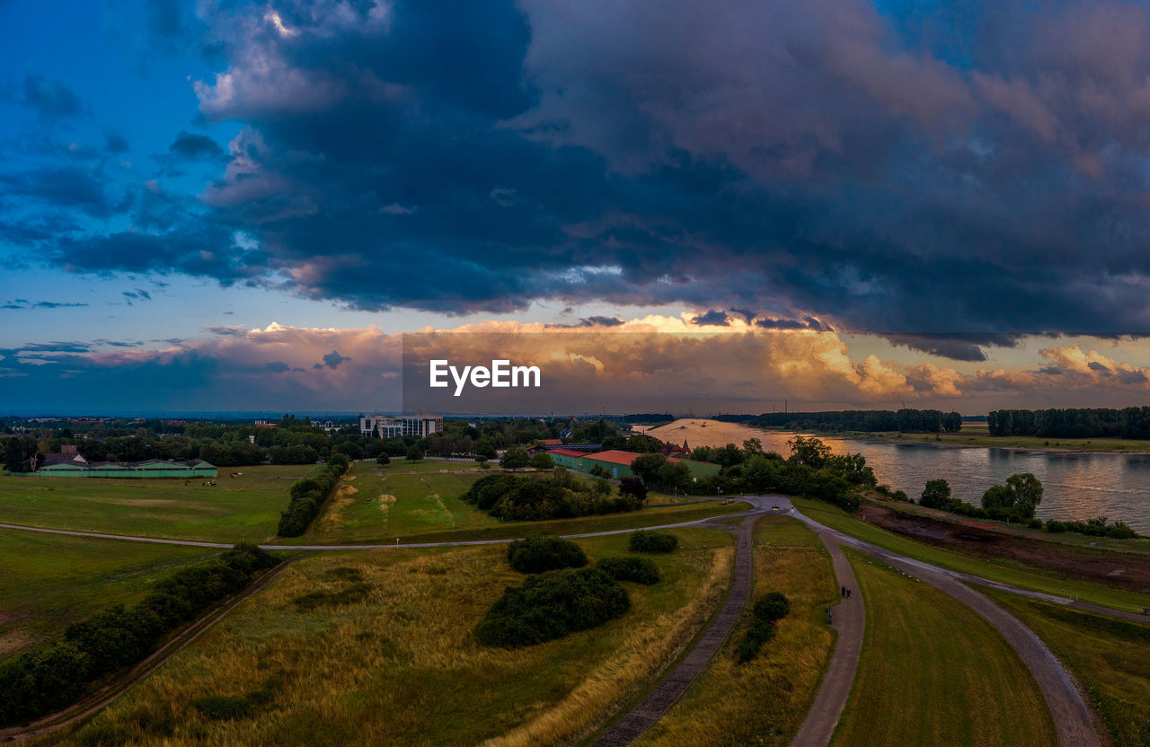 PANORAMIC SHOT OF ROAD AMIDST FIELD AGAINST SKY