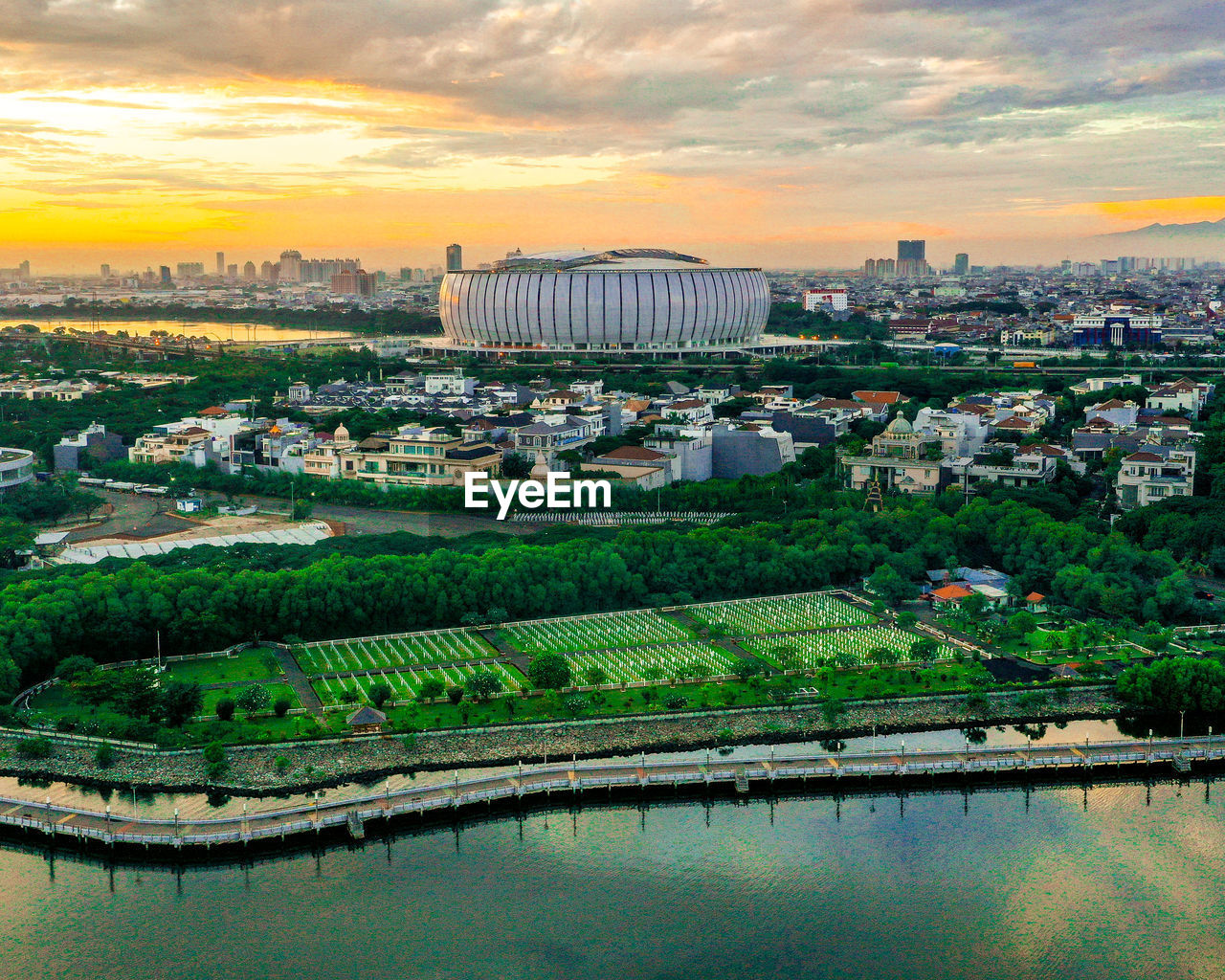 architecture, city, built structure, sunset, sky, building exterior, cityscape, landscape, water, building, cloud, nature, skyline, environment, travel destinations, aerial photography, horizon, reflection, river, travel, outdoors, scenics - nature, business finance and industry, tourism, dusk, high angle view, no people, residential district, aerial view, plant, bird's-eye view, beauty in nature, urban skyline, land, transportation, sun, industry, tree, construction industry, urban area, landmark, business