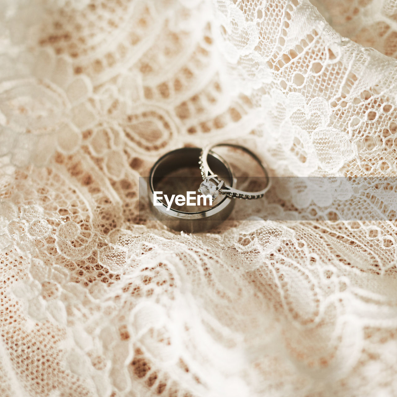 Two silver wedding rings with a lace background. jewelry for an engagement or valentines day