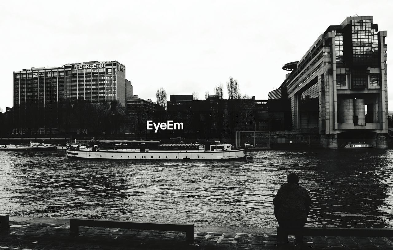 VIEW OF RIVER IN CITY AGAINST SKY