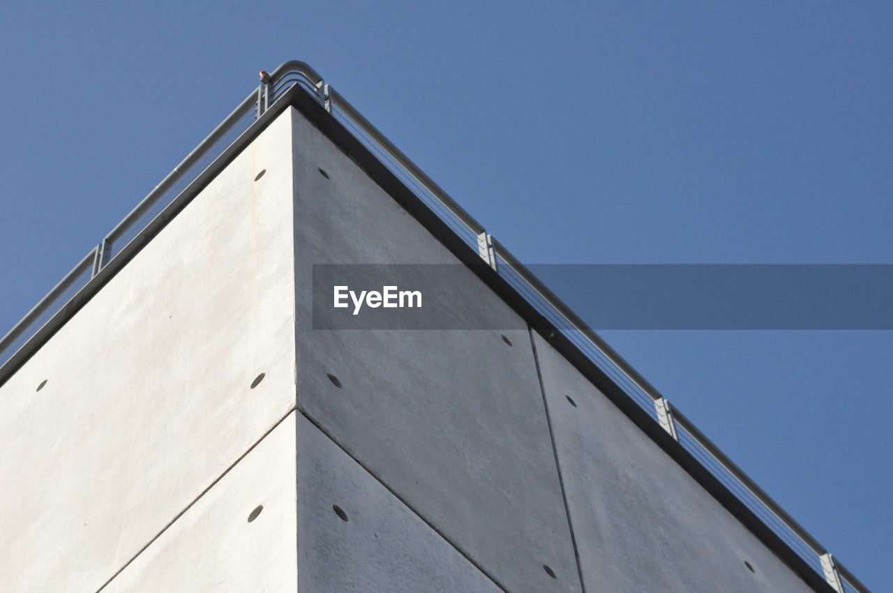 Low angle view of building against clear blue sky