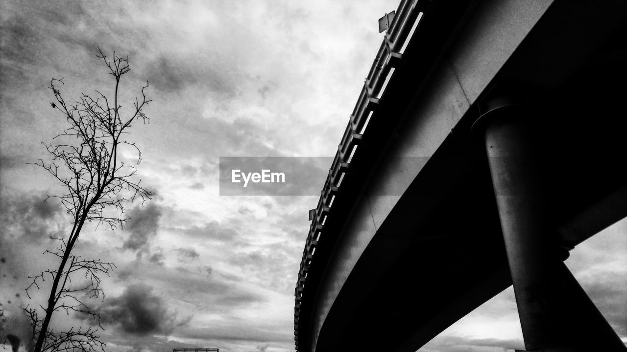 LOW ANGLE VIEW OF BRIDGE AGAINST CLOUDS