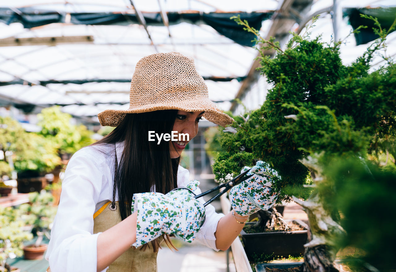 Woman working on table in greenhouse