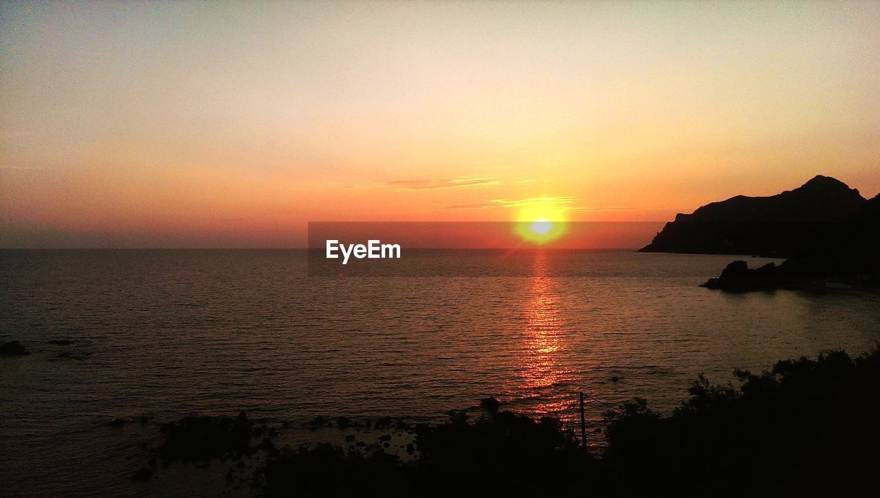 Scenic view of lake during sunset