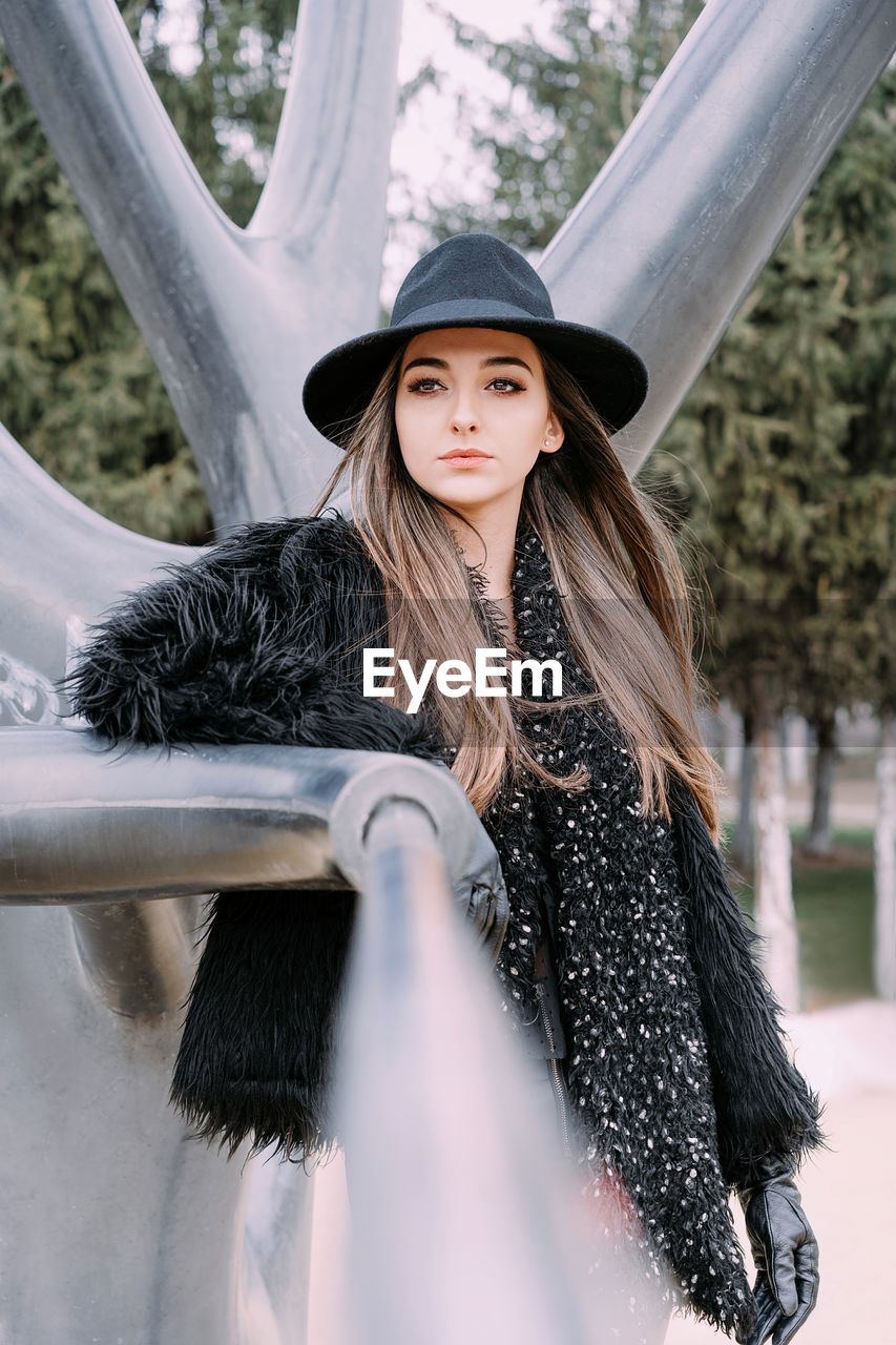 Portrait of beautiful young woman in hat