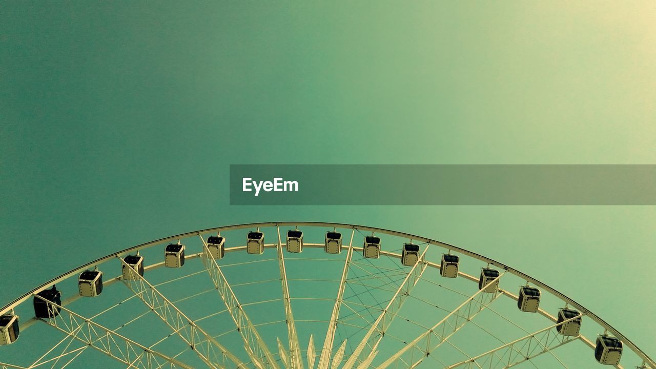 Low angle view of ferris wheel against clear sky