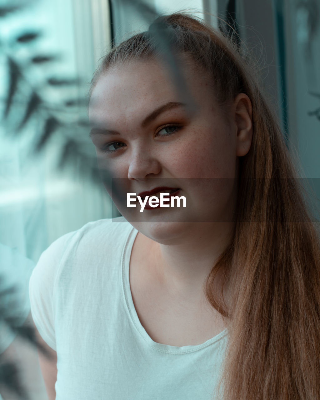 Portrait of young woman at home