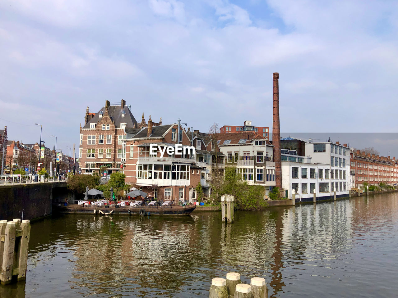 RIVER BY BUILDINGS AGAINST SKY