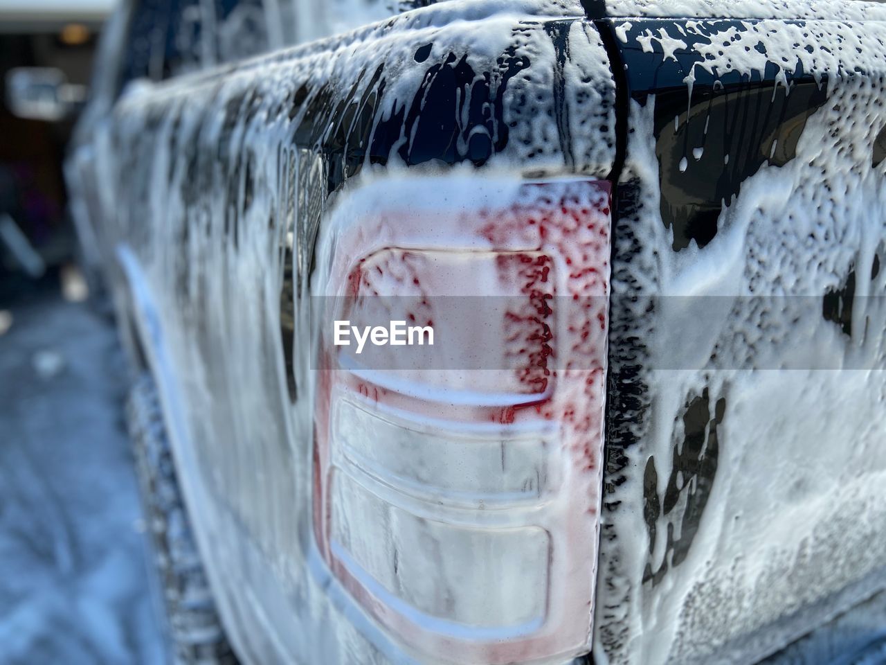 CLOSE-UP OF WET GLASS CAR